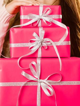 Woman holding presents box making gift in christmas time. Xmas concept.の写真素材