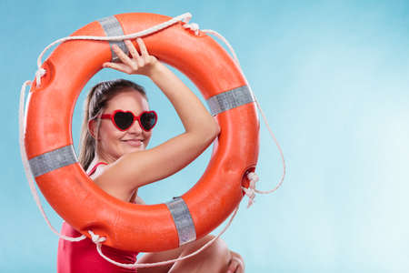 Happy glad young woman girl in heart shape sunglasses with ring buoy lifebuoy. Summer safety security.の写真素材