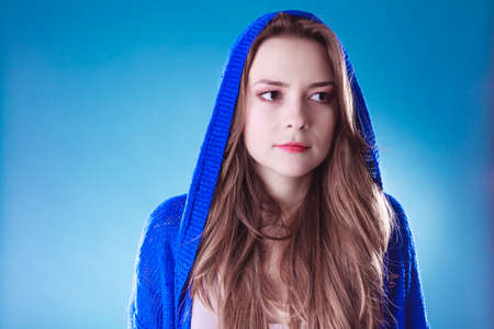 Young woman nowadays. Teenage girl in sweater with hood on head.