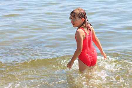 Little girl child having fun in ocean. Kid and woman bathing in sea water. Summer vacation holiday relax.の写真素材
