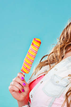 Summer vacation happiness concept. Smiling joyful and cheerful woman fashionable female model eating...