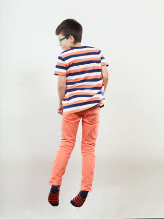 Active sweet cute kid little boy jumping in studio. Childhood.の写真素材