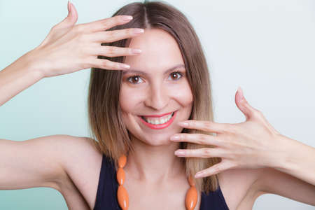 Portrait of attractive gorgeous happy joyful woman girl showing hands palms.の写真素材