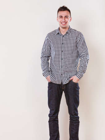 Portrait of handsome fashionable man in plaid shirt. Young guy posing in studio. Casual fashion.の写真素材