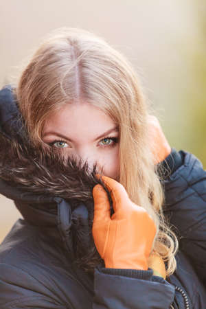Portrait of pretty attractive fashionable woman in fall forest park. Gorgeous blonde young girl in jacket. Autumn winter fashion.の写真素材