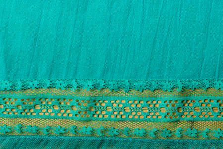 blue green cloth textile with decorative lace as background or border frameの写真素材