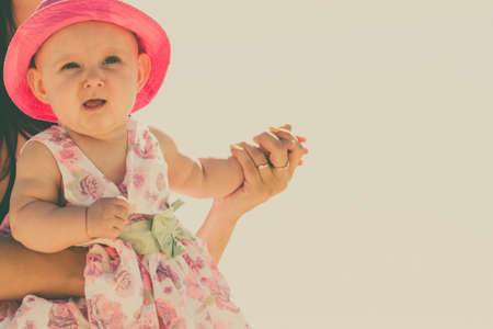 Closeup of sweet little baby in parent hands. Babyhood and parenting.の写真素材