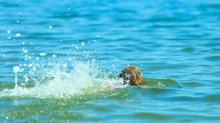Little girl child swimming in ocean. Kid and woman bathing in sea water. Summer vacation holiday relax.の写真素材