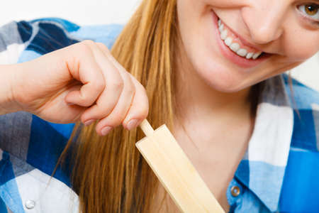 Woman assembling wooden furniture using screwdriver. DIY enthusiast. Young girl doing home improvement.の写真素材