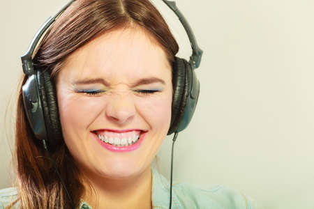 People leisure relax concept. Closeup happy woman big headphones listening music mp3 relaxingの写真素材