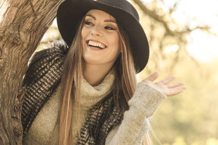 Young beauty woman wearing stylish autumnal clothes relaxing in park. Portrait of fashionable caucasian girl student resting on air.の写真素材