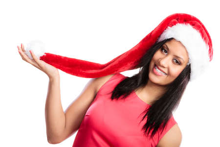 Christmas winter happiness concept. Young woman girl mixed race wearing santa helper hat portrait. White backgroundの写真素材