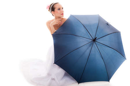Wedding day at a raining day. Full length romantic bride white gown holding blue umbrella isolated on whiteの写真素材