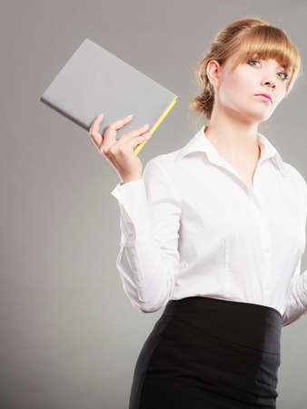 Pensive young woman girl holding book textbook. Education leisure.の写真素材