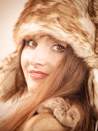 Winter fashion. Happy young woman wearing fashionable wintertime clothes fur cap portraitの写真素材