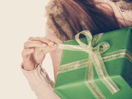 Closeup of human person with green box gift isolated on white. Birthday anniversary concept.の写真素材