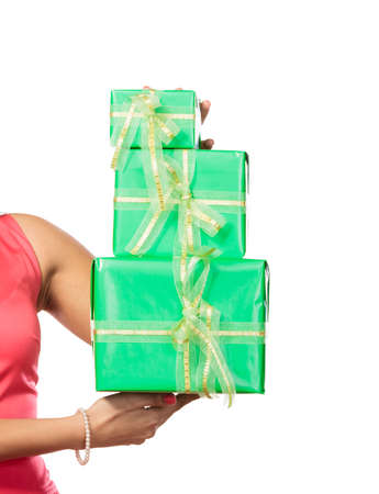 Closeup of human hands with green boxes gifts isolated on white. Birthday anniversary concept.