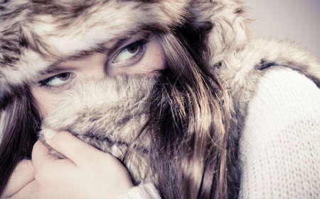 Beauty and fashion of women. Wintertime concept. Portrait of attractive cute girl in fur cap hat. Studio shot.の写真素材