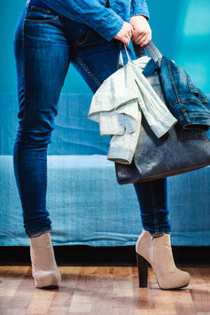 Customer with bag shopping. Girl in denim jeans trousers. Fashion clothing sale.の写真素材