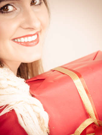 Pretty attractive latin woman holding red box gift. Birthday anniversary christmas concept.