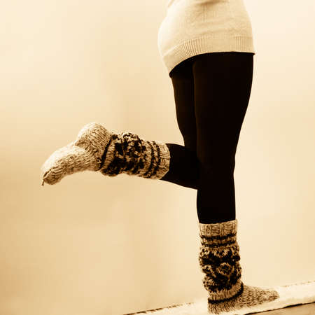 Winter fashion. Woman legs in black pantyhose and stylish fashionable woolen warm socksの写真素材