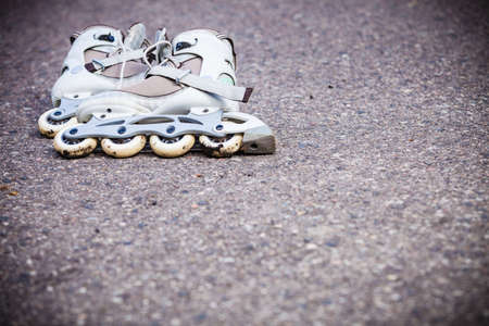 Active fun leisure in spring summer outdoor activities concept. Closeup roller skates on asphalt.