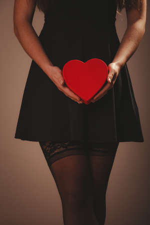 Beauty, sexuality and seductiveness. Sexy part body woman wearing black dress and stockings panties...