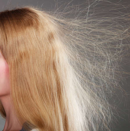 Closeup of woman girl with static blonde long hair.の写真素材