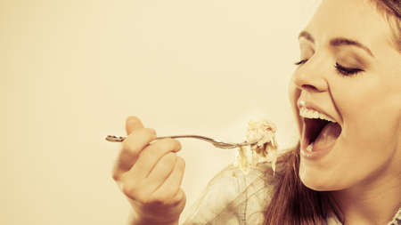 smiling young woman eating salad.