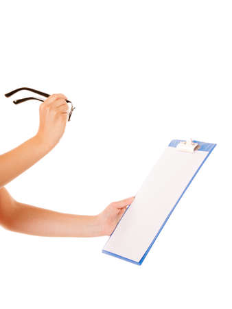 woman holding glasses and clipboard in hands studio shot, isolated on whiteの写真素材