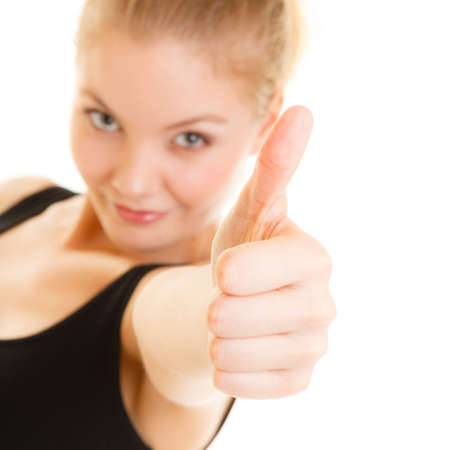 Health care healthy lifestyle. fit fitness sport woman thumb up sign hand gesture. Smiling happy sporty girl. Isolated on whiteの写真素材