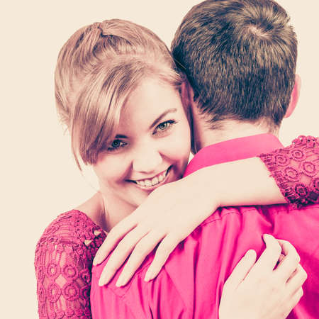 Young beauty woman hug man romantically. Couple in love on date. Filtered photoの写真素材