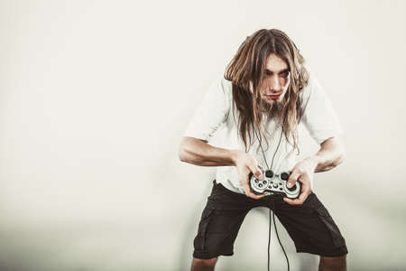 Lifestyle of young people. Student man spending time on playing games videogames console . Long...