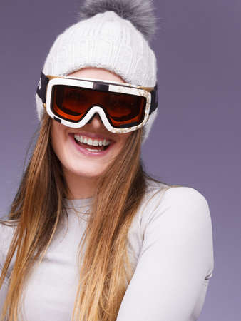 Attractive woman in winter cap gray sports thermal underwear for skiing training ski googles studio...