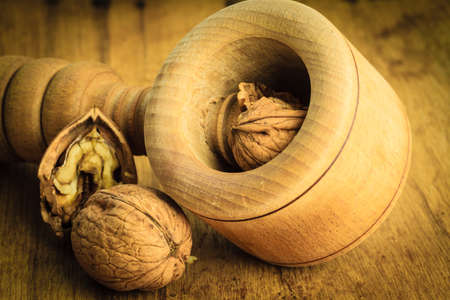 Healthy food full of omega-3 fatty acids, organic nutrition. Closeup walnut and nutcracker on rustic...
