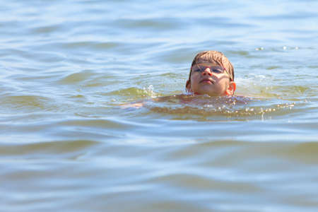 Little girl child swimming in ocean. Kid and woman bathing in sea water. Summer vacation holiday relax.の写真素材