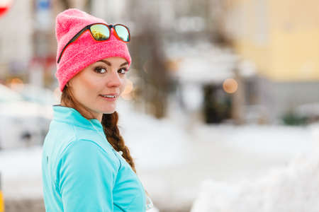 Sports and activities in winter time. Slim fit fitness woman outdoor. Athlete girl training wearing...