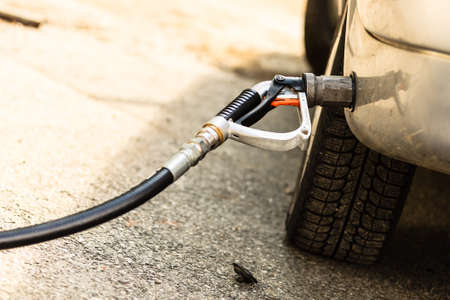 Auto refuel. Car at gas station being filled with fuel, fill up of liquefied petroleum gas, LPGの写真素材