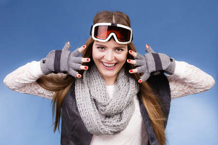 Woman skier girl wearing warm clothing ski googles portrait. Winter sport activity. Beautiful...