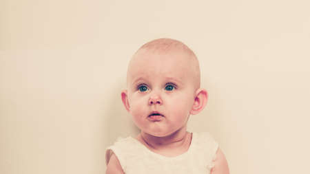 Happy childhood. Lovely little child girl. Portrait of cute sweet adorable baby.の写真素材