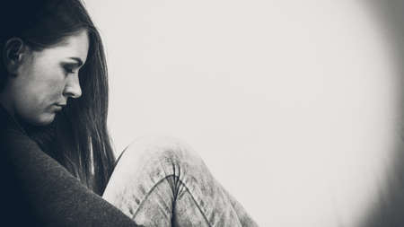 Face emotional expression of sadness. Unhappy worried thinking woman, depressed girl deep in thought. Female contemplating life.の写真素材