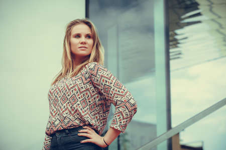 Fashion and style. Beauty young blondie woman posing outdoors. Gorgeous fashionable model wearing stylish clothes.の写真素材