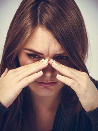Sinus ache causing very paintful headache. Unhealthy woman in pain. Sharp strong sore.
