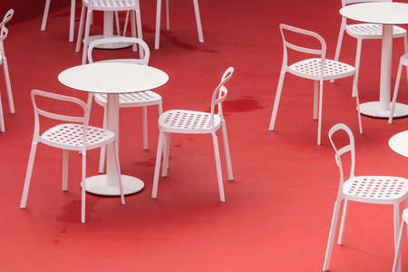 View on empty white table and chairs in outdoor restaurant.の写真素材