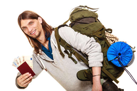 Man tourist backpacker holding passport full of money. Young guy hiker backpacking. Summer vacation...
