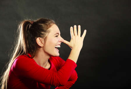 Happy joyful woman girl mocking having fun playing the fool in studio on black.