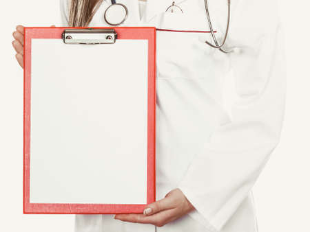 Medical doctor with stethoscope and clipboard isolated. Professional health care advertisement.の写真素材