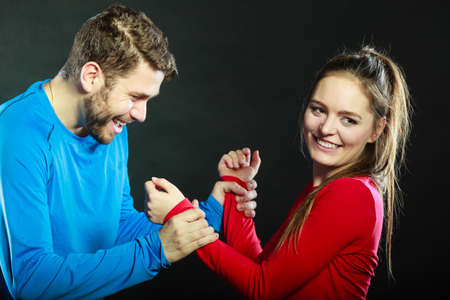 Portrait of smiling woman and man posing in studio on black. Happy joyful couple. Good relationship.の写真素材