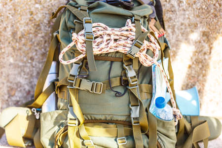 Hiking backpack camping and mountain exploring tourist equipment outdoor on grunge wall. Adventure, summer, tourism active lifestyleの写真素材