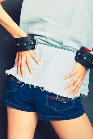 Arrested girl with handcuffs. Punishment woman going to jail.の写真素材